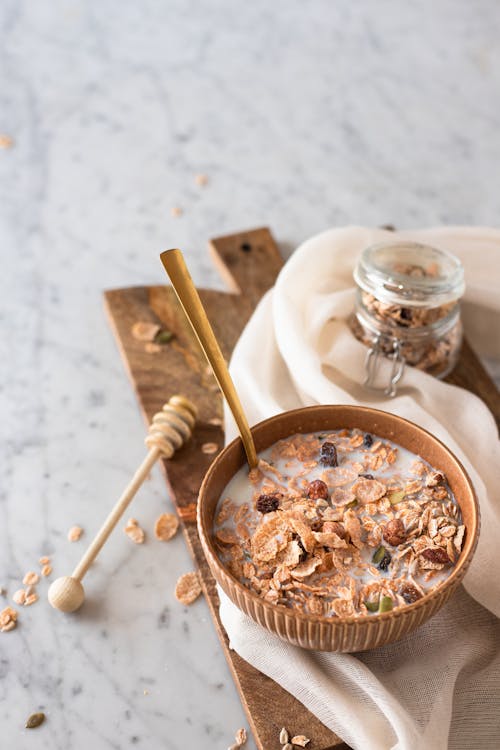 Cereal Bowl Beside a Honey Dipper