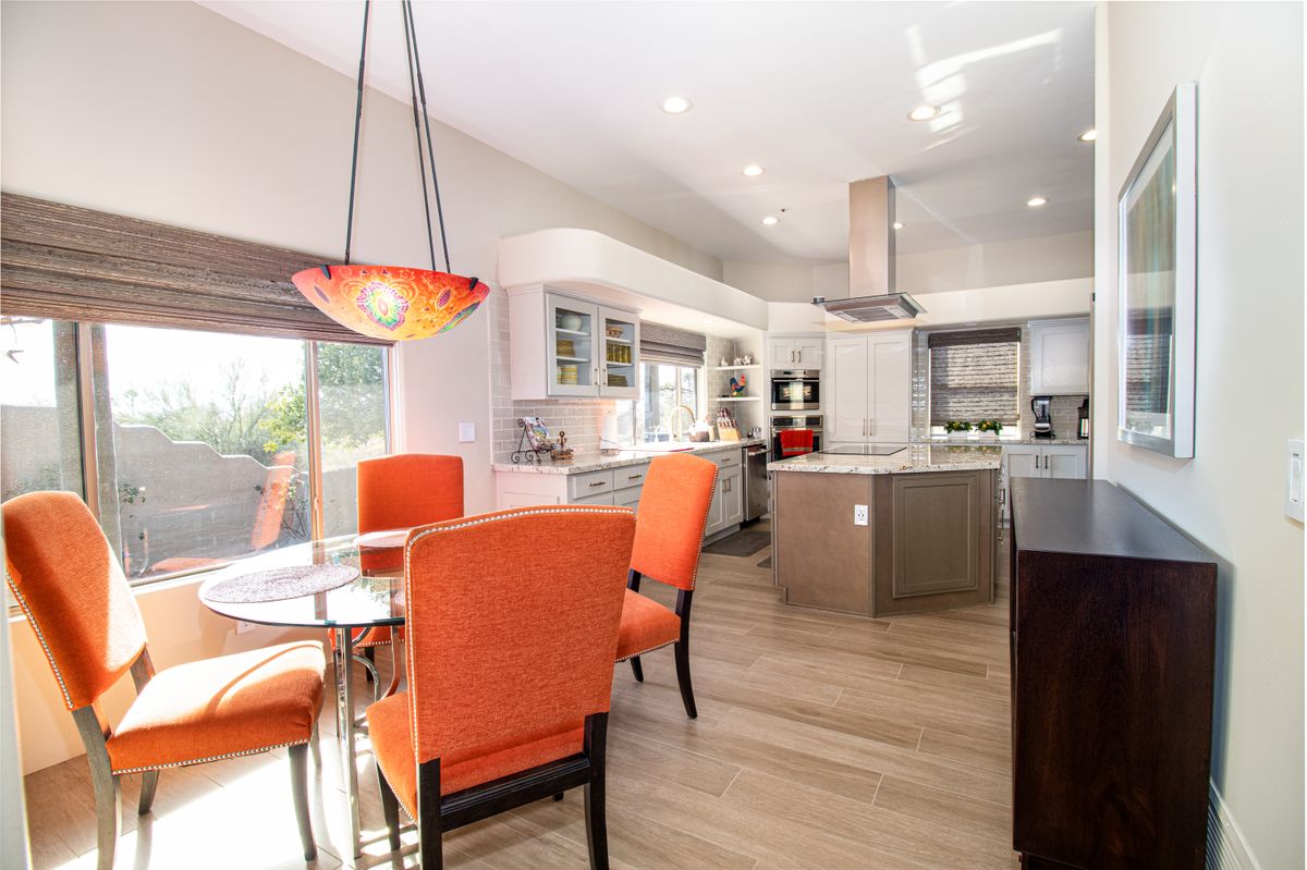 Open remodeled kitchen with island and connected dining area