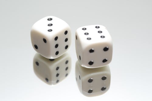 Free Pair of White Dice on Top of Mirror Stock Photo
