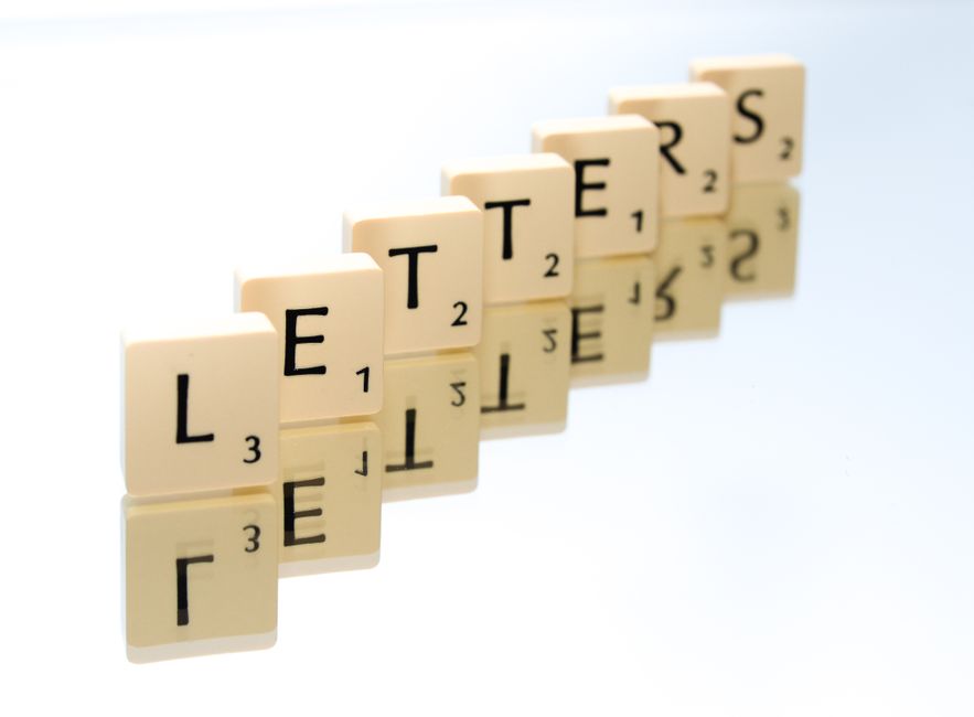 'letters'と綴られたスクラブルタイルが滑らかな表面に明確に反射しています。