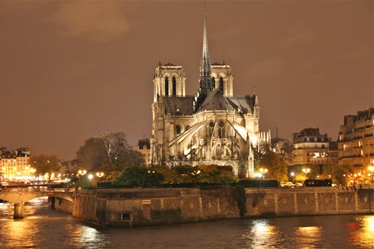 A stunning night view of the illuminated Notre Dame Cathedral in Paris, France.