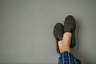 Person Wearing Blue and White Plaid Shorts and Black Slip on Shoes