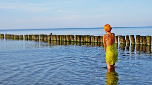 Woman in a Dress Swimming at the Beach