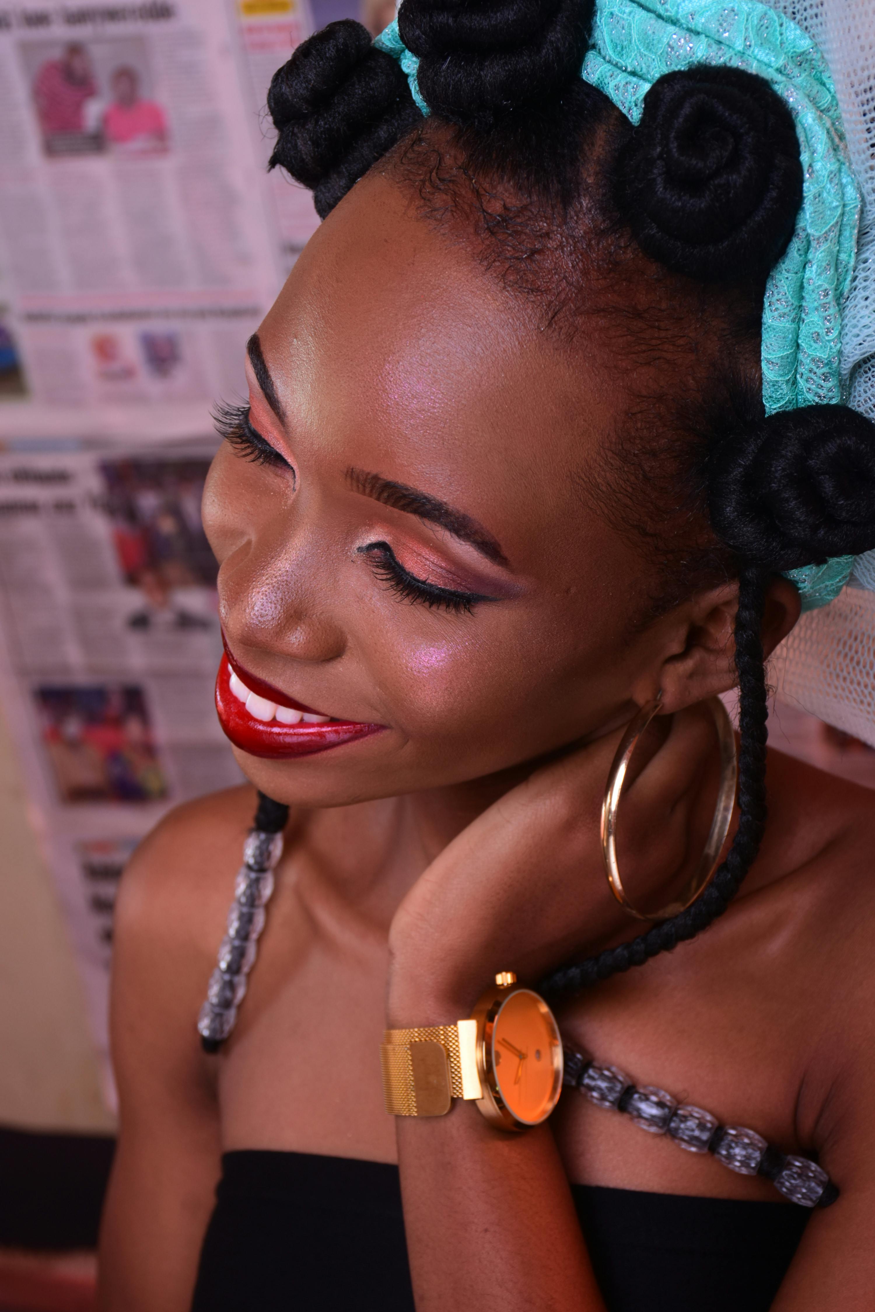 A joyful woman with stylish hair and accessories, showcasing modern beauty.