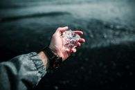 Person Holding Clear Crystal Fragment