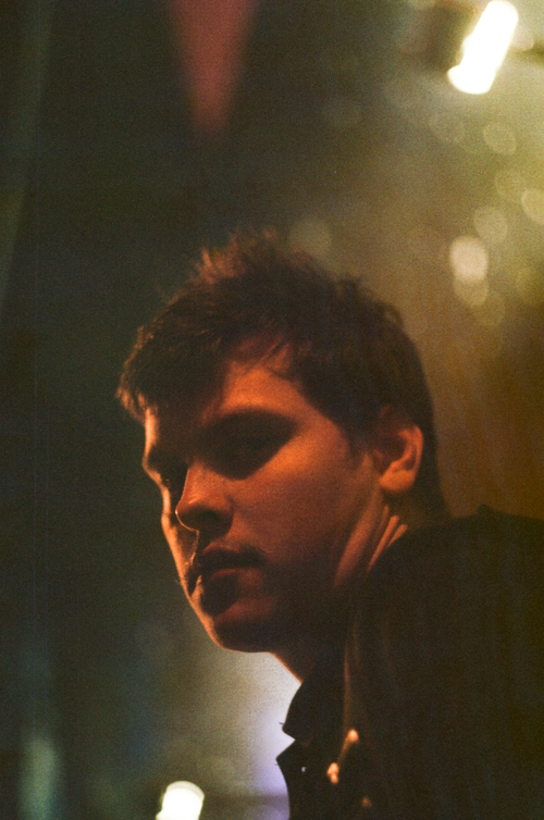 Free Moody portrait of a young man in dim lighting with a thoughtful expression. Stock Photo