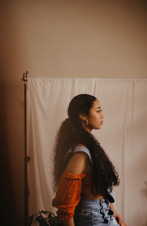 Side View of a Woman with Long Curly Hair