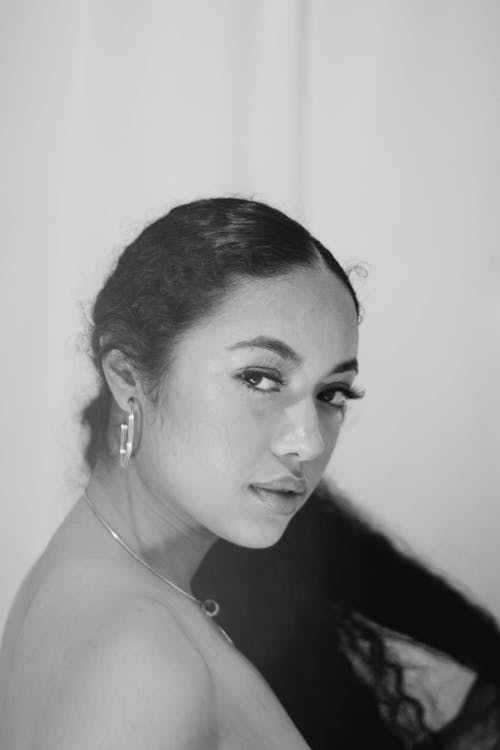 Monochrome Portrait of a Woman with a Necklace Looking at the Camera