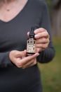 Person Holding Brown Glass Bottle