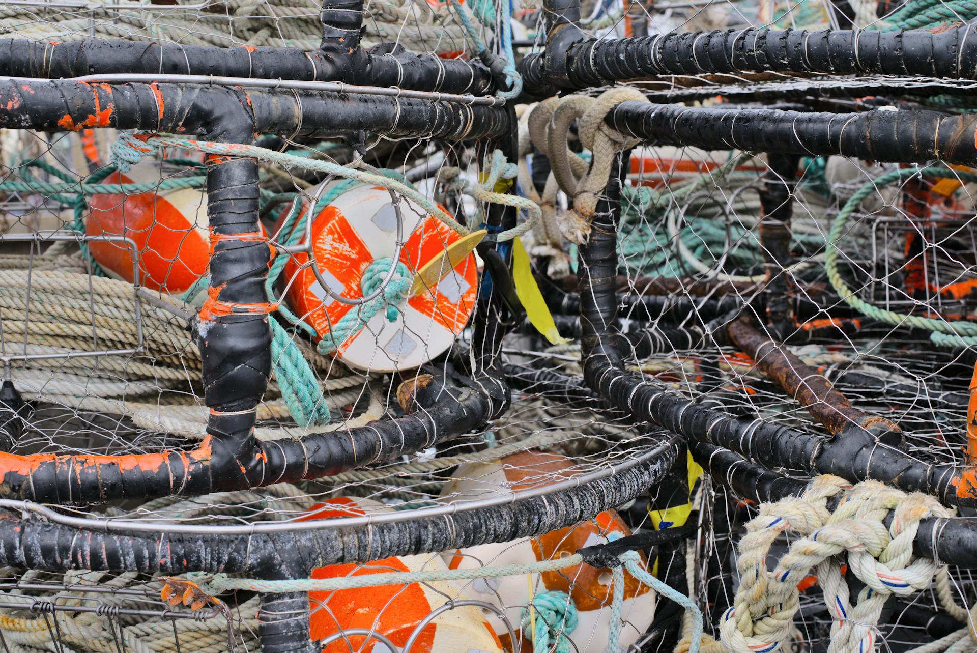 Close-up of stacked crab pots with colorful buoys and ropes at Eureka Harbor, California.