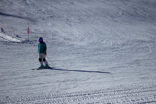 Person in Blue Jacket Skiing