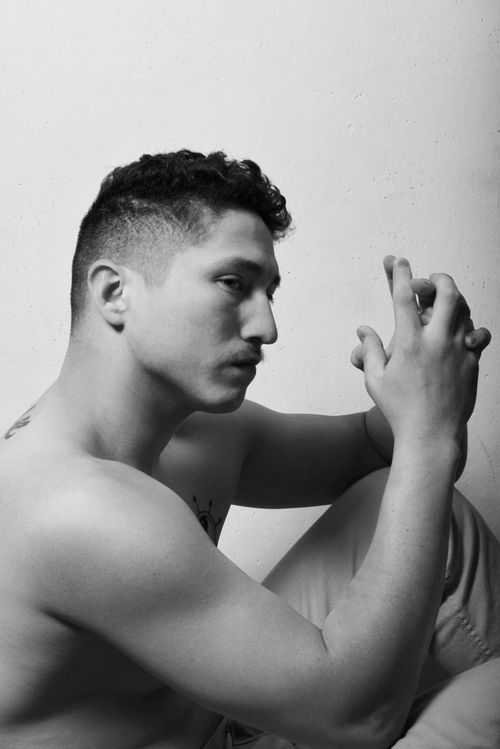 Free Black and white side view of thoughtful male with naked torso and tattoo looking away Stock Photo