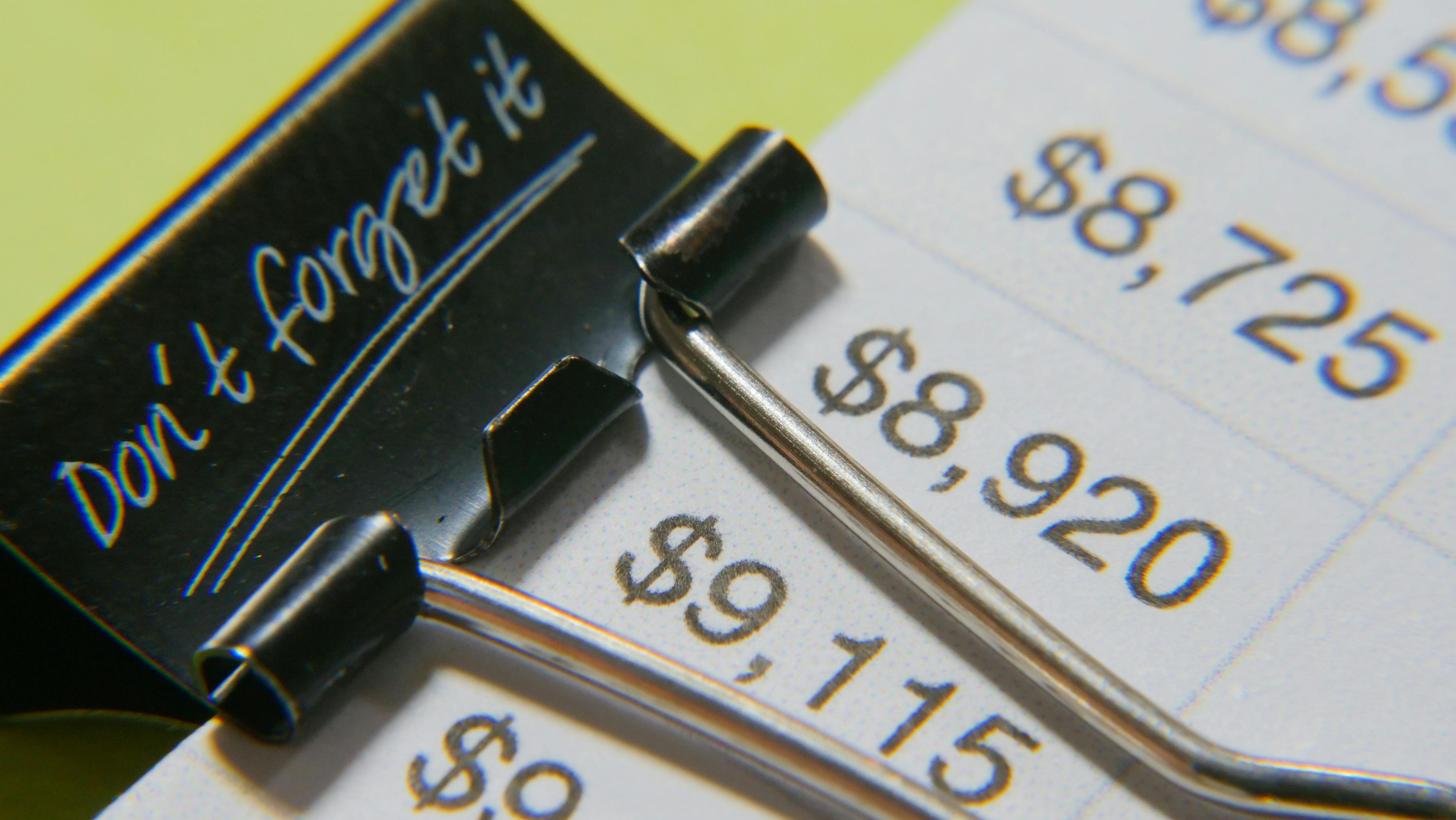 a close up shot of a document with a binder clip