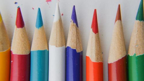 Free Close-up of sharpened colored pencils in various vibrant hues on a white background. Stock Photo