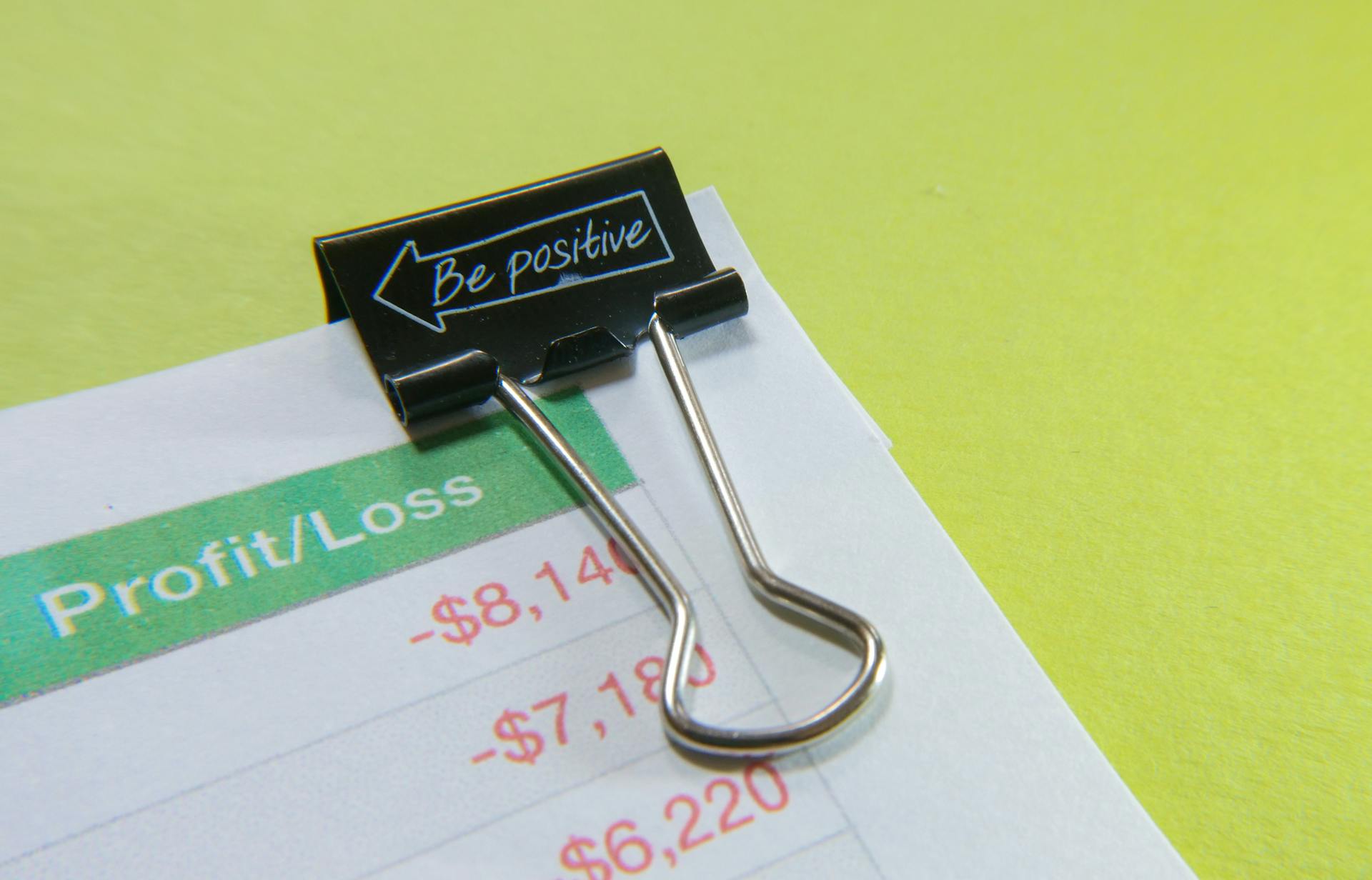 Binder Clip on Paper with Profit and Loss Statement