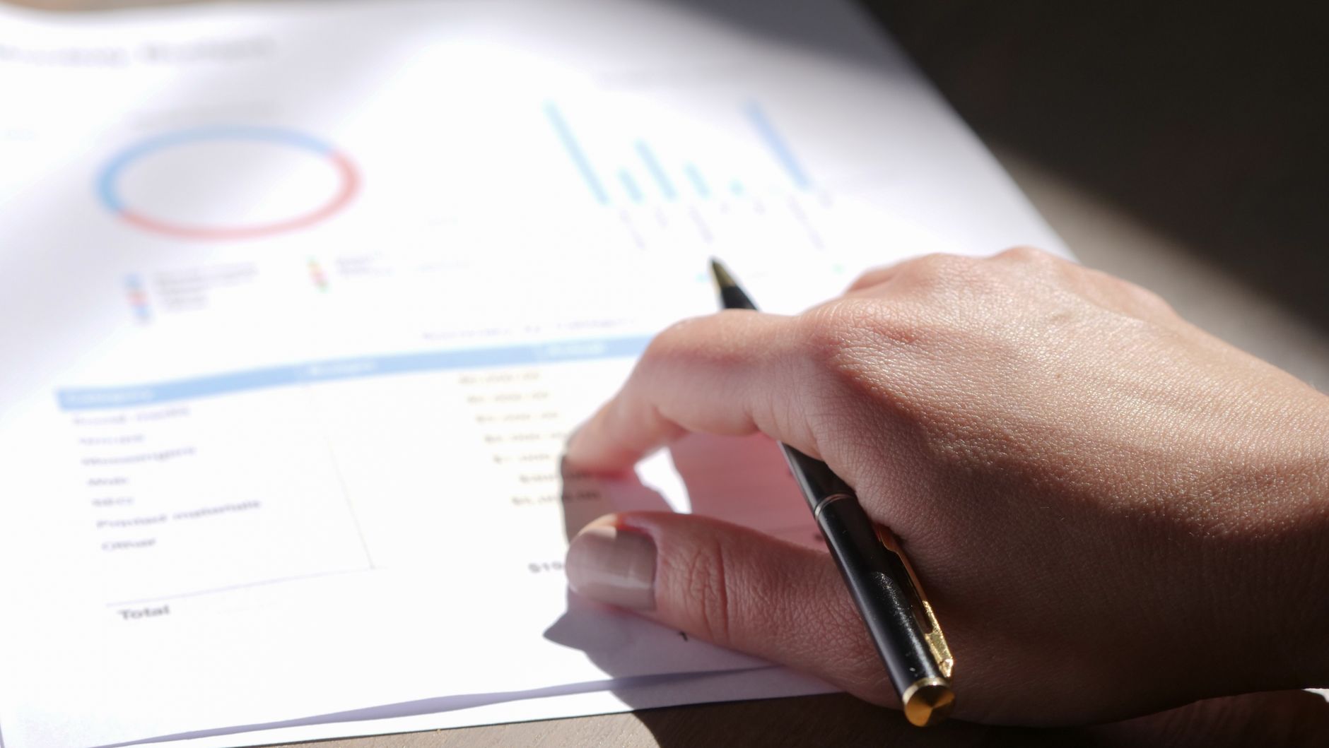 Person examining financial charts for custom project financing in London Ontario Person examining financial charts for custom project financing in London Ontario