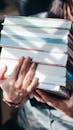 A Person Carrying a Stack of Books