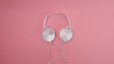 Stylish white headphones on a pink background. Perfect for music and lifestyle concepts.