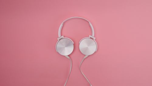 Free Stylish white headphones on a pink background. Perfect for music and lifestyle concepts. Stock Photo