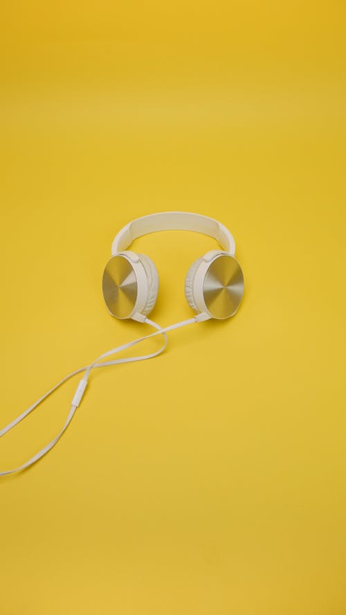 White Corded Headphones on Yellow Surface