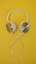 White Headphones on Yellow Background