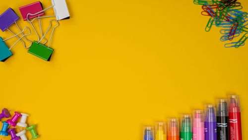 Free Arrangement of office supplies on a bright yellow background with ample copy space. Stock Photo