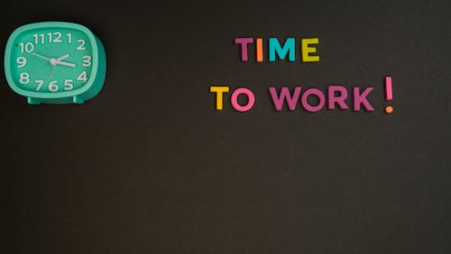 Free Time to Work Text on Black Surface Stock Photo
