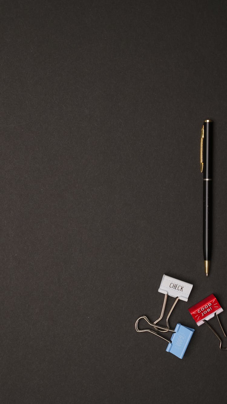 Photo Of A Black Pen Near Binder Clips