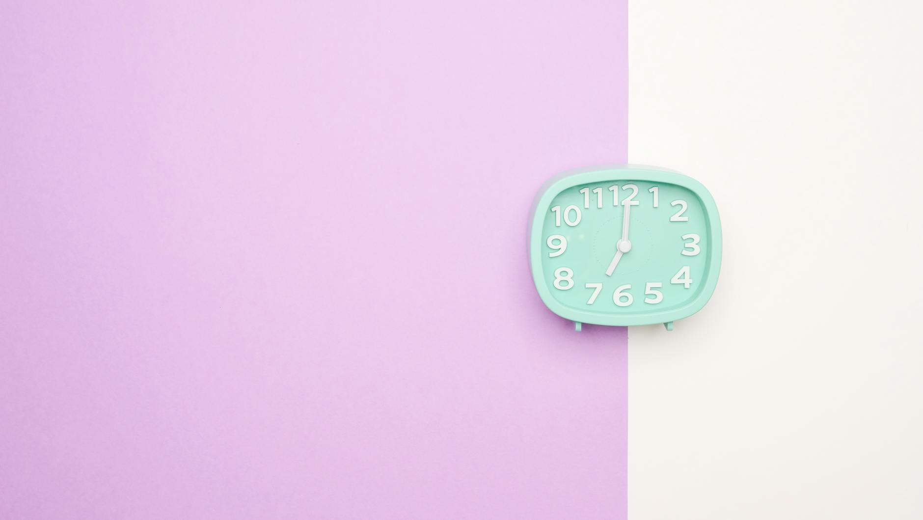 Teal Color Clock on Pink and White Surface