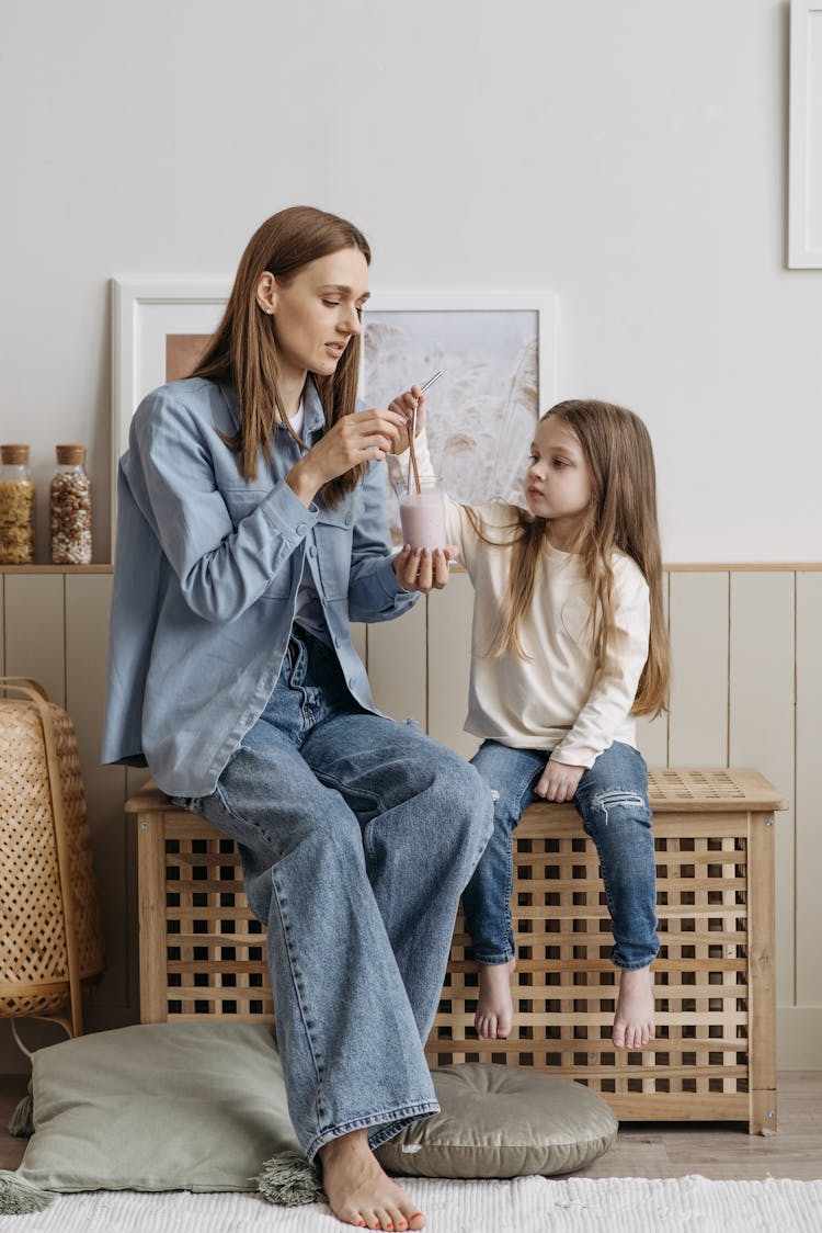 Photo Of A Mother And Her Daughter Sharing A Drink