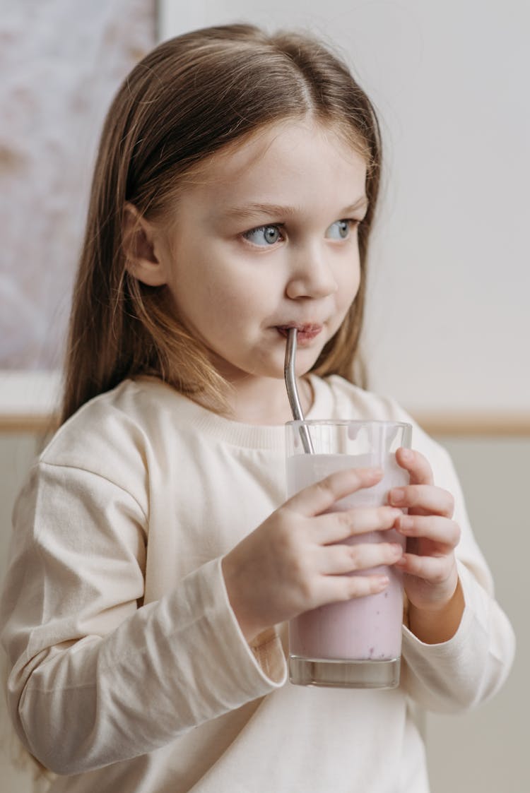 A Pretty Girl Drinking On Straw
