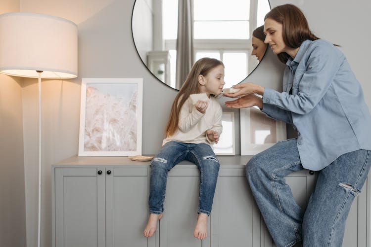 Photo Of A Kid And Her Mother Smelling A Soap Bar