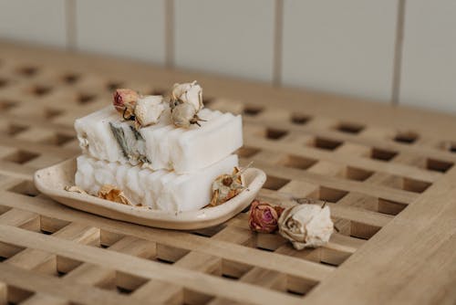 White Bar Soaps and Dried Roses on Ceramic Tray