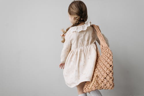 Little Girl in Floral Dress with Shoulder Bag