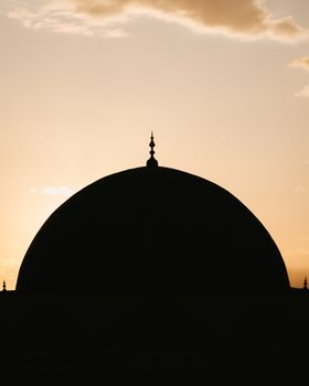 A captivating silhouette of a dome set against a vibrant sunset, highlighting the elegant architecture.. captivating, silhoue