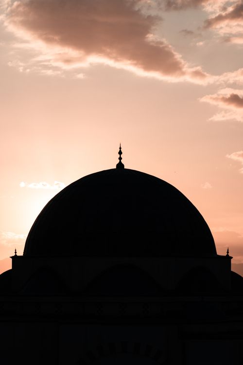Free Silhouette of a mosque dome at sunset, highlighting its architectural elegance. Stock Photo