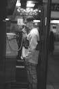 Man Making a Telephone Call from a Phone Booth