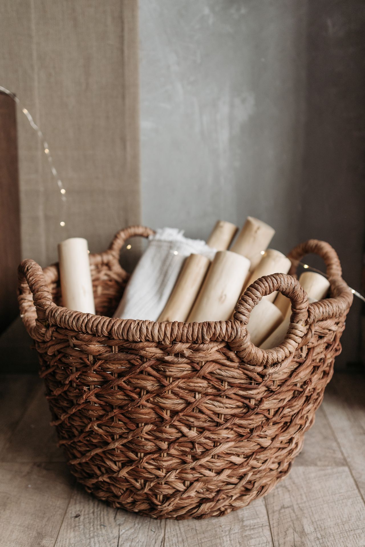 garage-gallery-woven-basket Woven basket filled with rolled towels and fabric
