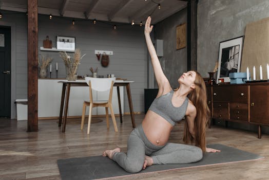 Pregnant woman practicing yoga indoors, promoting wellness and a healthy lifestyle.