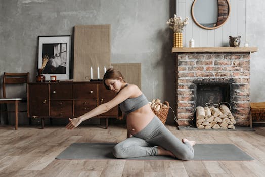 Pregnant woman doing yoga at home, focusing on wellness and relaxation.