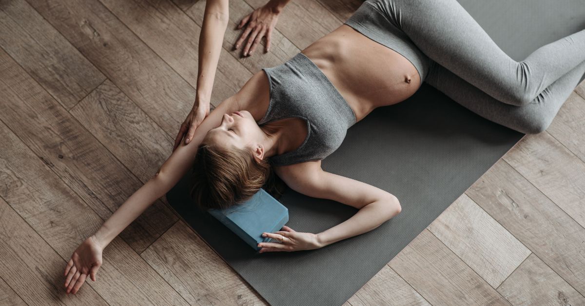 overhead view of person in 90/90 hip stretch position on a mat