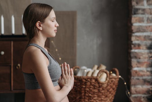 Calm pregnant woman practicing yoga and meditation indoors for relaxation.