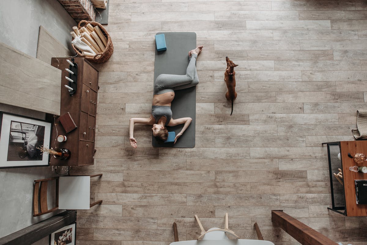 Pregnant woman doing light exercise on yoga mat
