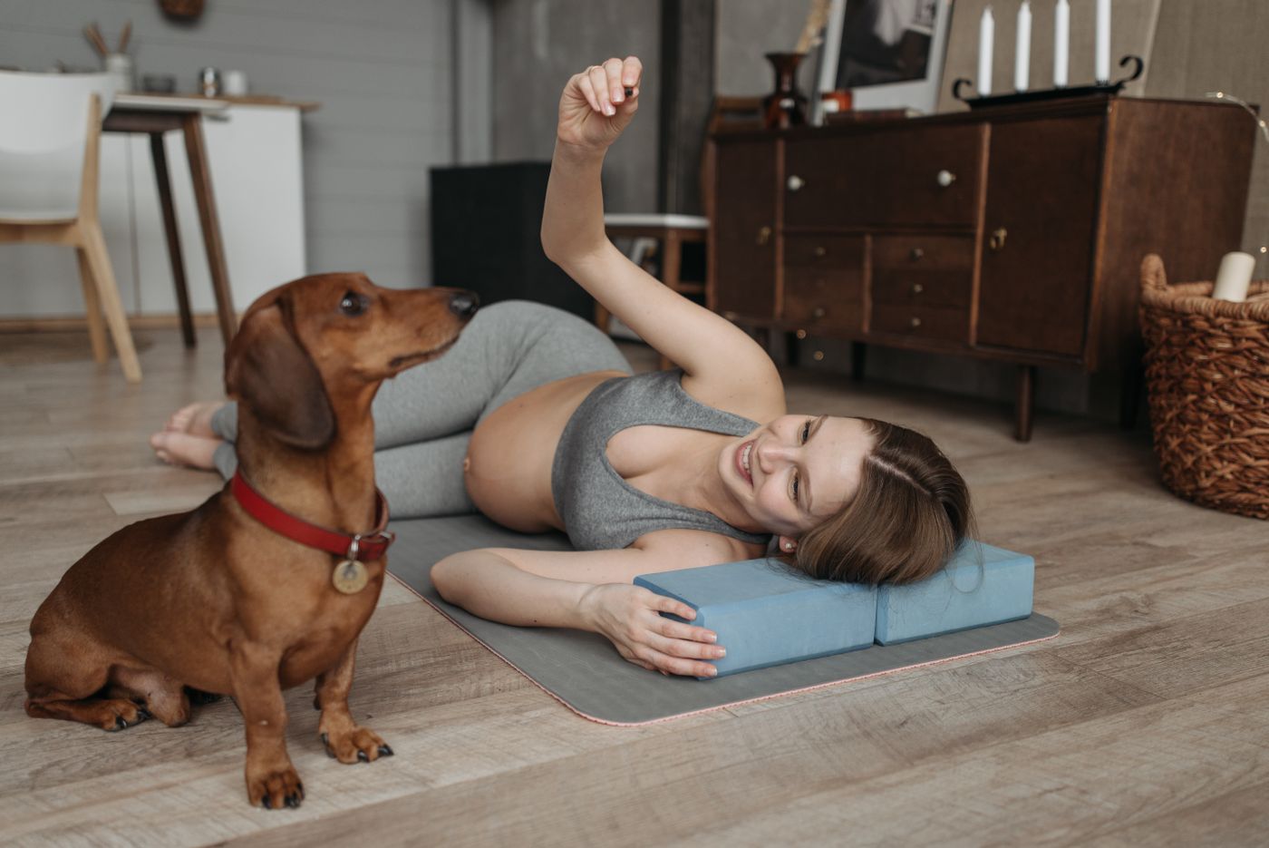 A playful dog enjoying a happy indoor moment beside a person