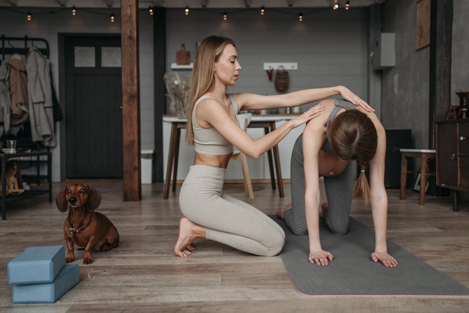 Two women engaging in yoga practice indoors with a dachshund dog in a relaxing setting.