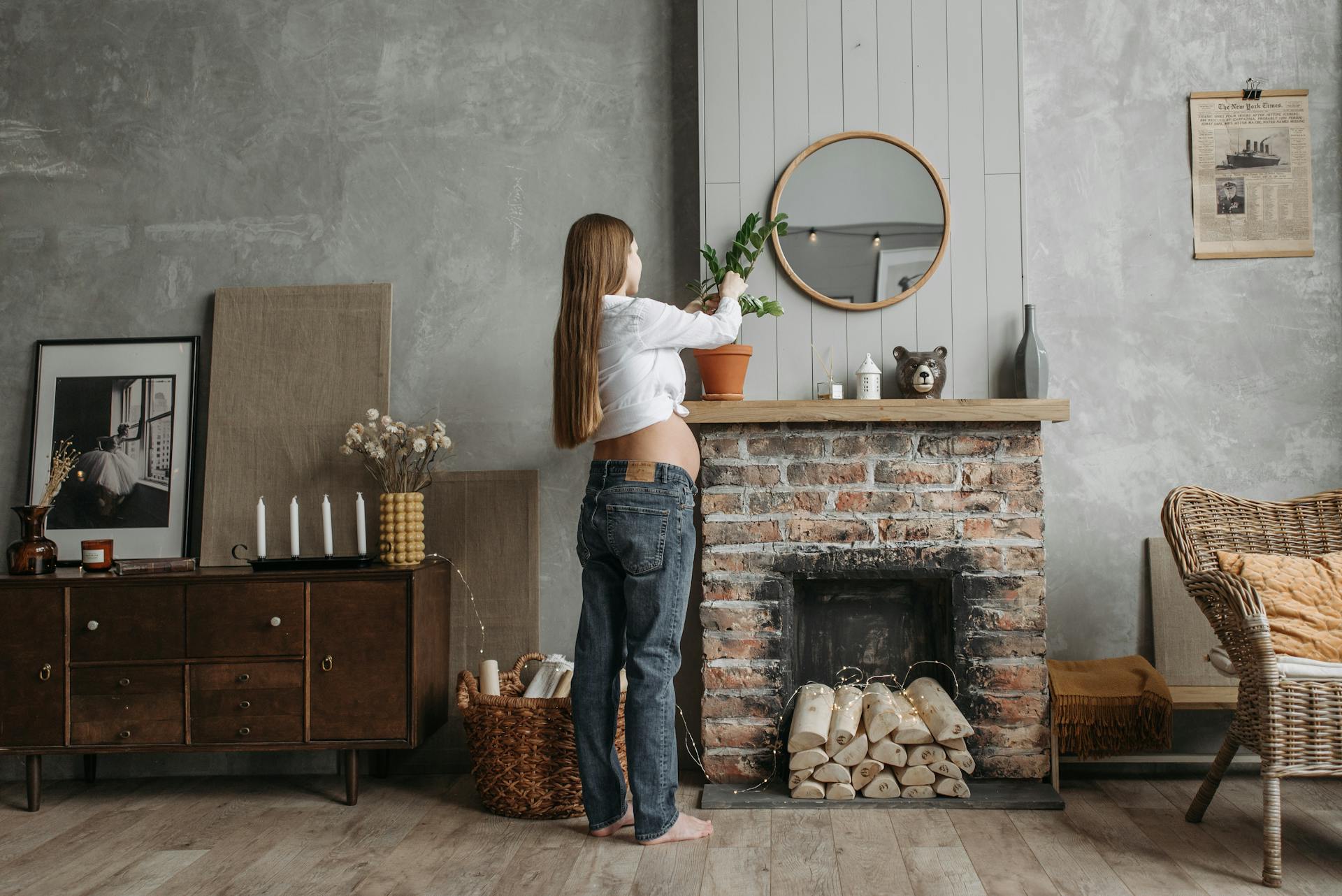 A Pregnant Woman Caring for an Indoor Plant