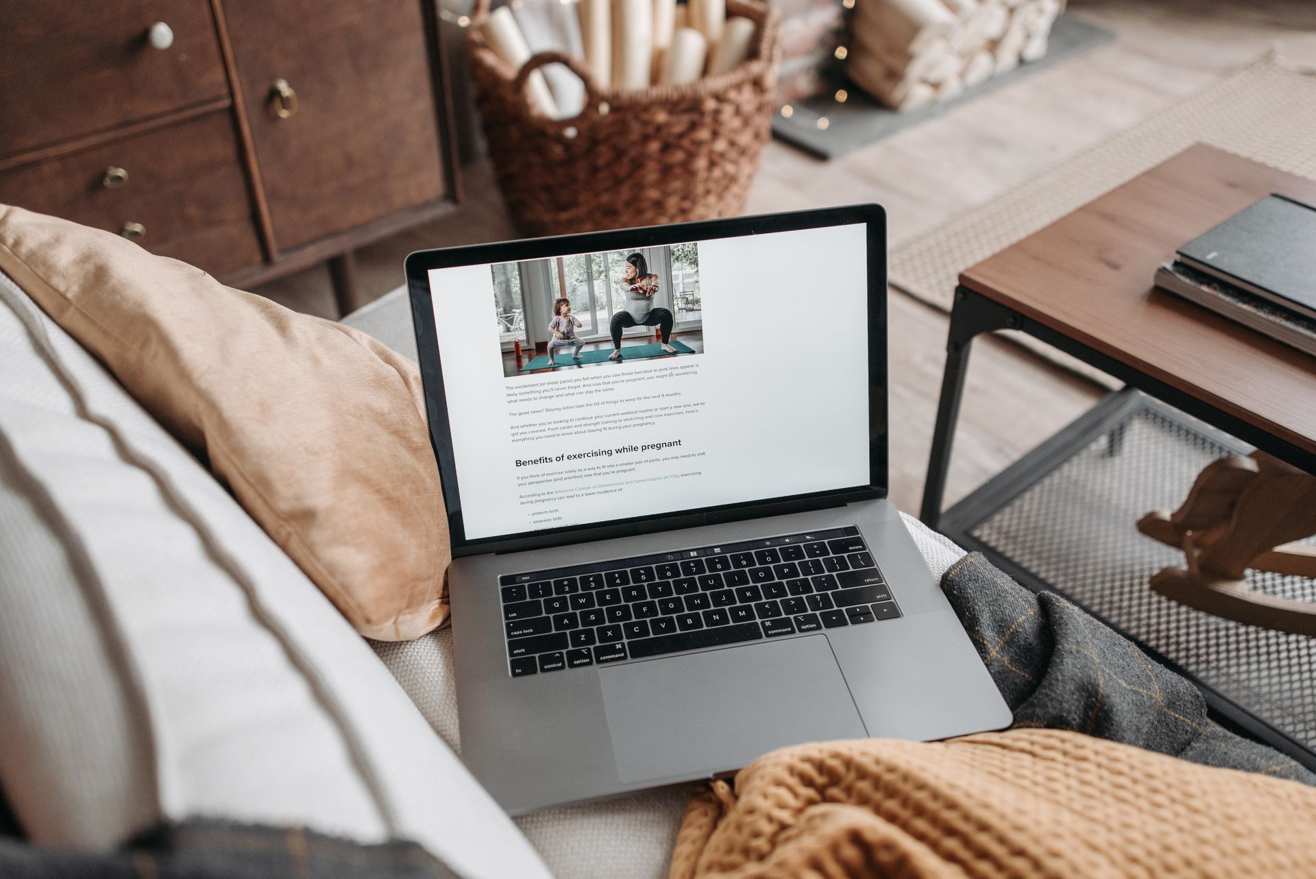 Laptop displaying fitness content in a cozy, well-decorated living room setting.