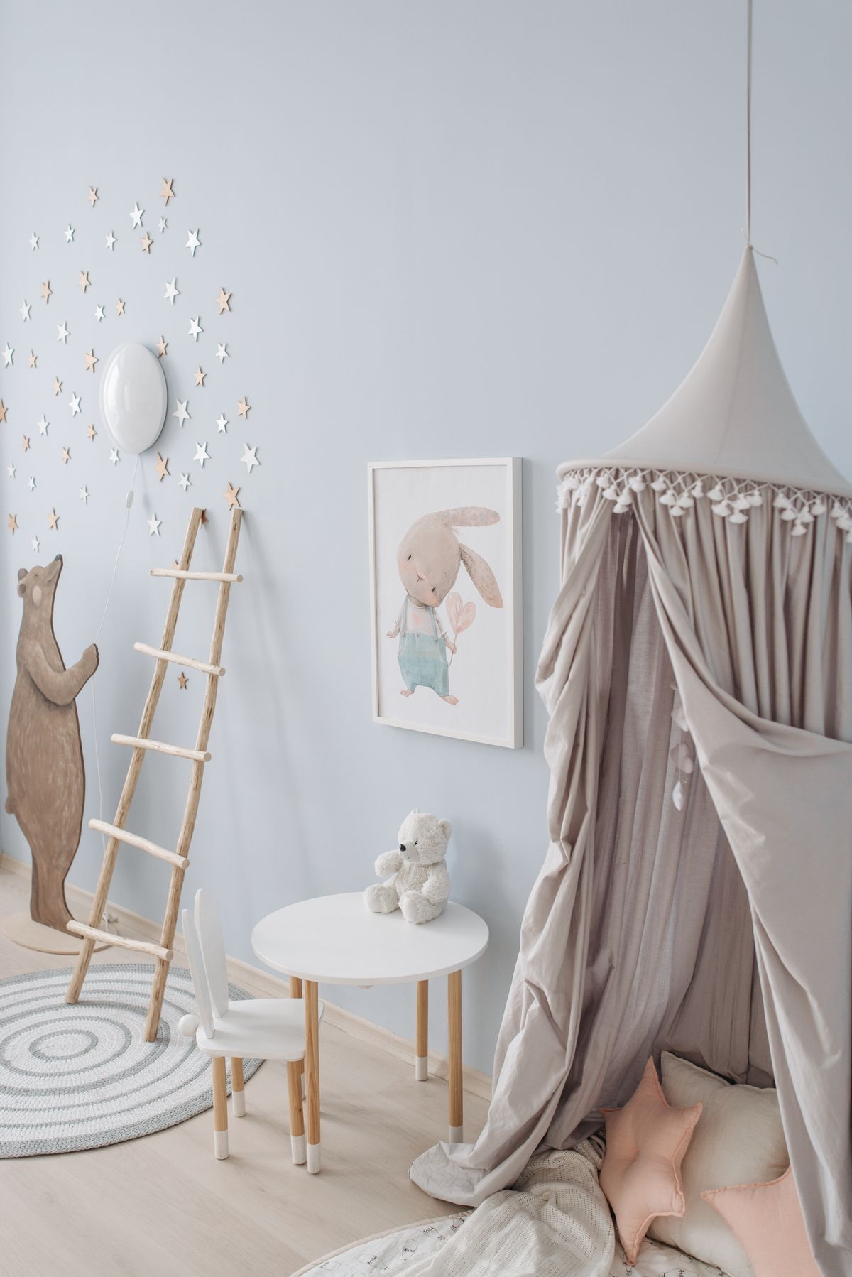 Playful kids room with canopy, wooden toys, and pastel decor