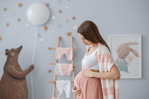 Free A Pregnant Woman Rubbing Her Belly Stock Photo