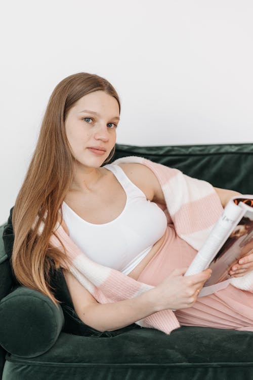 Free A Pregnant Woman Reading a Magazine Stock Photo